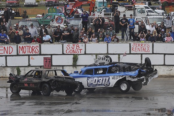 The West End Motors car upends Andy Reandeau's car during the Demo Derby Monday