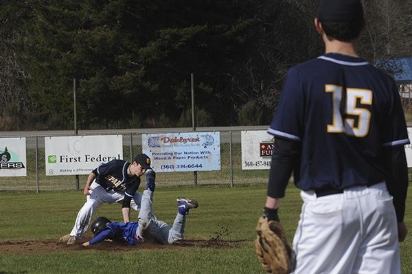 Spartan infielder Reis Lawson tags the Elma runner out at second after taking a perfect throw from catcher Reece Hagen. Looking on is first baseman Reece Moody. Elma took this one 12-0.