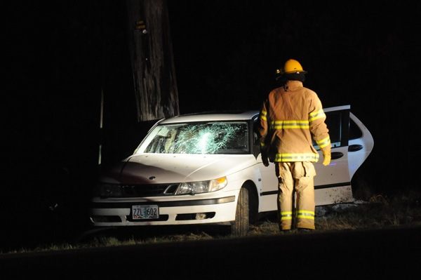 A Beaver fireman inspects the car that ended up against two poles