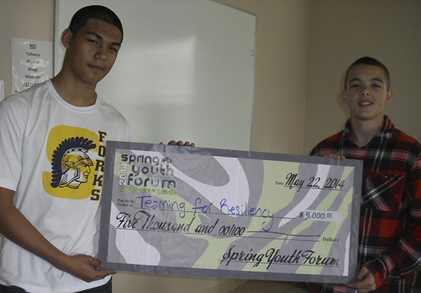 Adan Almazon and Jeffrey Schumack with their big check that will help them get to Washington