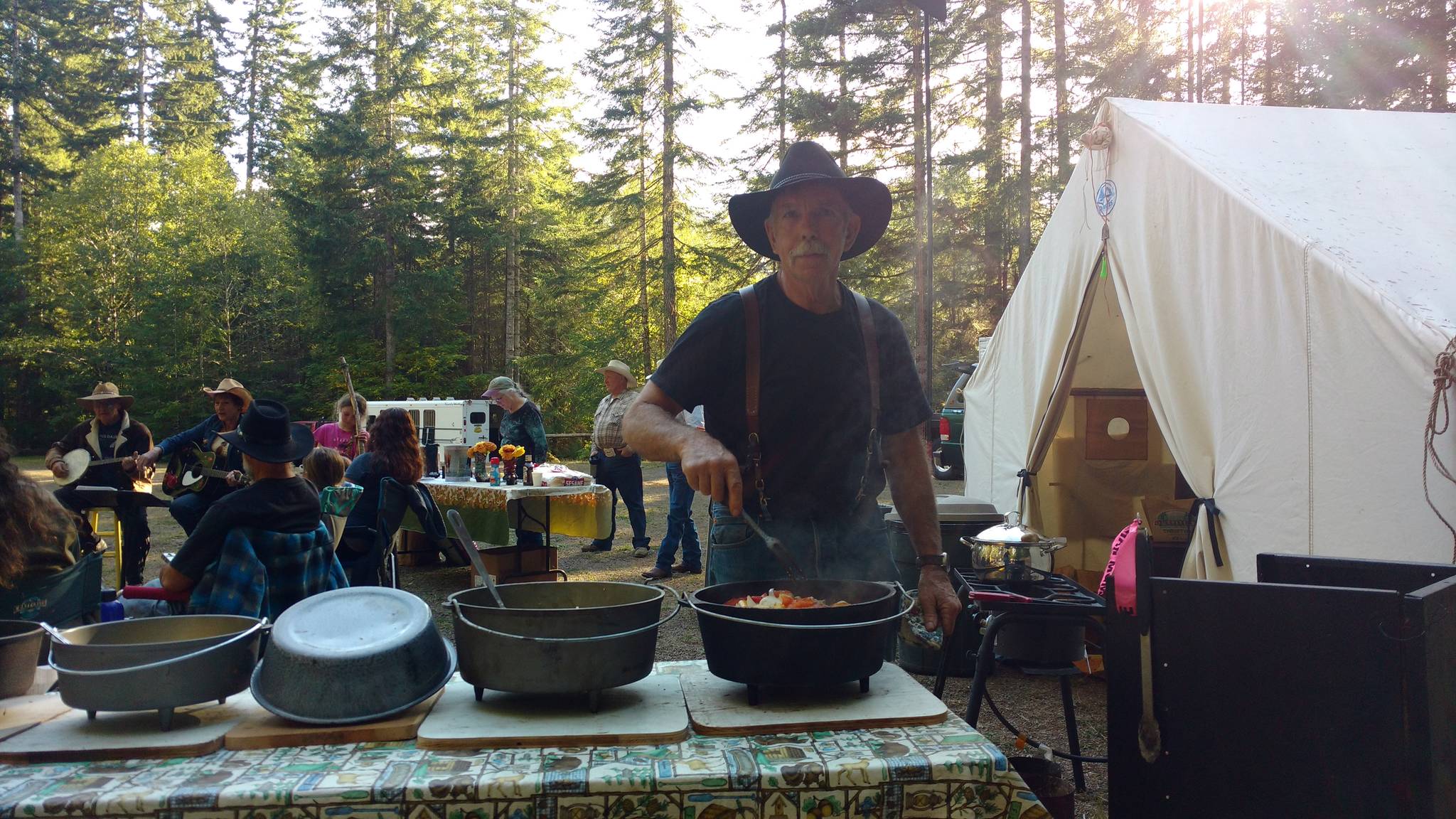 Above, Larry Baysinger sets                                 out the Dutch oven meal at the Littleton​ Horse Camp.                                 Photo Zorina Barker