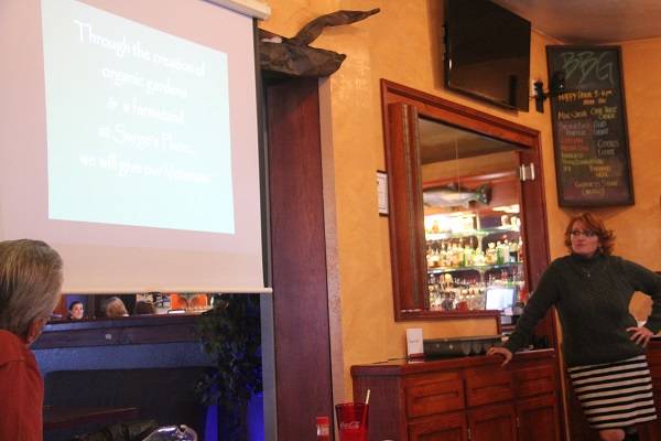 Cheri Tinker looks on as a video plays that was used in2 the recent Coast Works competiton. Photo Christi Baron