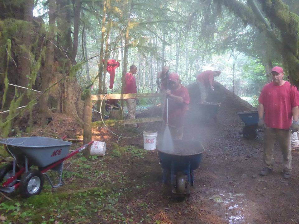 The OCC crew members pressure wash the gravel.