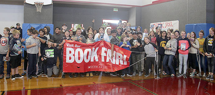 Update: An anonymous donor wanted to make sure that every student in the Junior High that wanted a book got one. With this donation and the others, 97 students will be able to pick out a book of their choice this week! Sarah purchased all of the books on Friday afternoon, and they were delivered at this special assembly on Monday! Photo Christi Baron