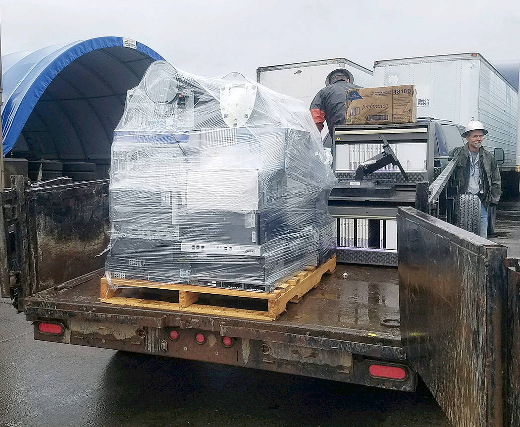 Lions Club members Tim Fletcher and Brian Olson unload E-Cycled items in Tacoma. Submitted Photos