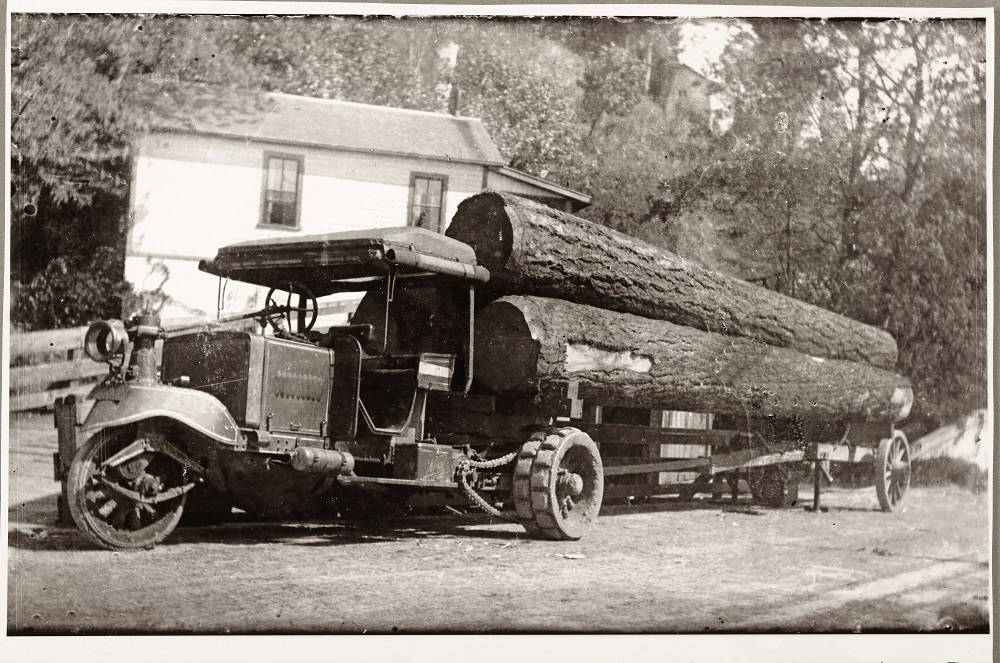 Three Wheel Truck Hauling Logs.