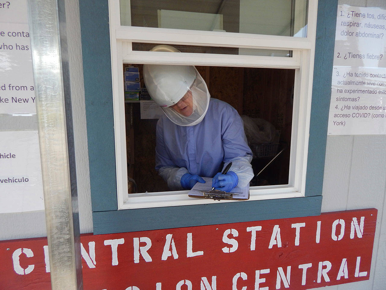 Workers at the check-in station outside the Bogachiel Clinic screens patients for all hospital and clinic business between the hours of 7 a.m. and 7 p.m. Once evaluated, patients get a sticker and a mask if they do not have their own. They then are allowed to enter the buildings in order to take care of their health care needs. (Christi Baron/Forks Forum)