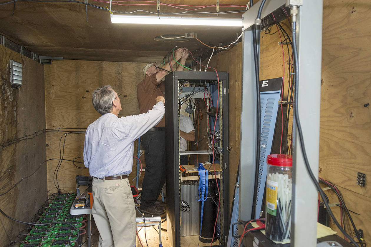 Technicians work to install the new equipment.