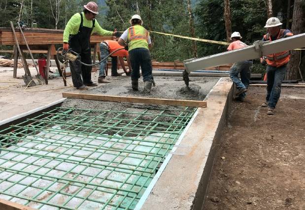 Placing the concrete for the approach slabs at the Canyon Creek bridge.