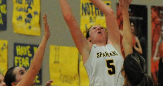 Spartan Keira Johnson scores 2 of her 26 points between Winlock defenders during this play-off game held in Forks Saturday afternoon. Forks defeated Winlock 59 to 55 to advance in District 4 play. Photo by Lonnie Archibald