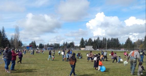 Egg hunting got underway under sunny skies at Tillicum Park at 11 a.m. sharp as Forks Police Chief Mike Rowley gave everyone the “Go” over his vehicle’s PA system. Only a few hours later and these egg hunters would have been hunting in the snow, hail, and rain. Photo Christi Baron