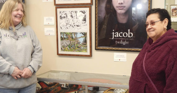 Before the celebration outside the collection, Andros met with Pokey Woodruff alongside a case of Quileute items recently added to the collection. Woodruff had suggested the items to Andros and they were purchased a few months ago. Photo Christi Baron