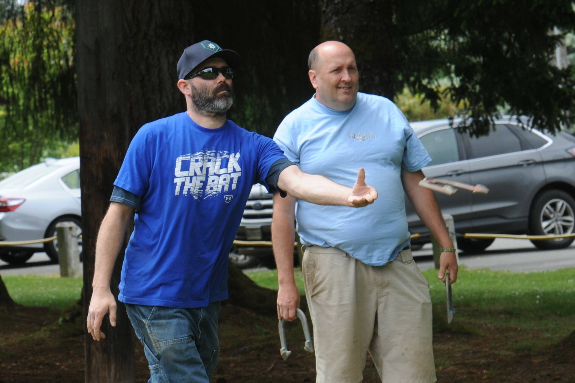 Wade McCoy (right) looks on as Jon Whitehead attempts to throw a ringer at Tillicum Park during the championship game Saturday. The team of Wade McCoy and Troy Pearce won over Jr. Dean and Jon Whitehead who placed second. Photo by Lonnie Archibald