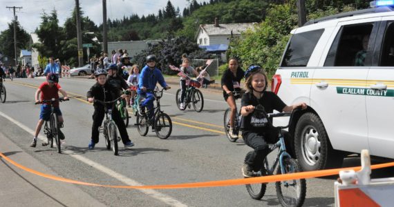 The Fun Days parade begins with bicycle riders escorted by the Clallam County Sheriff’s Department. Photo by Lonnie Archibald