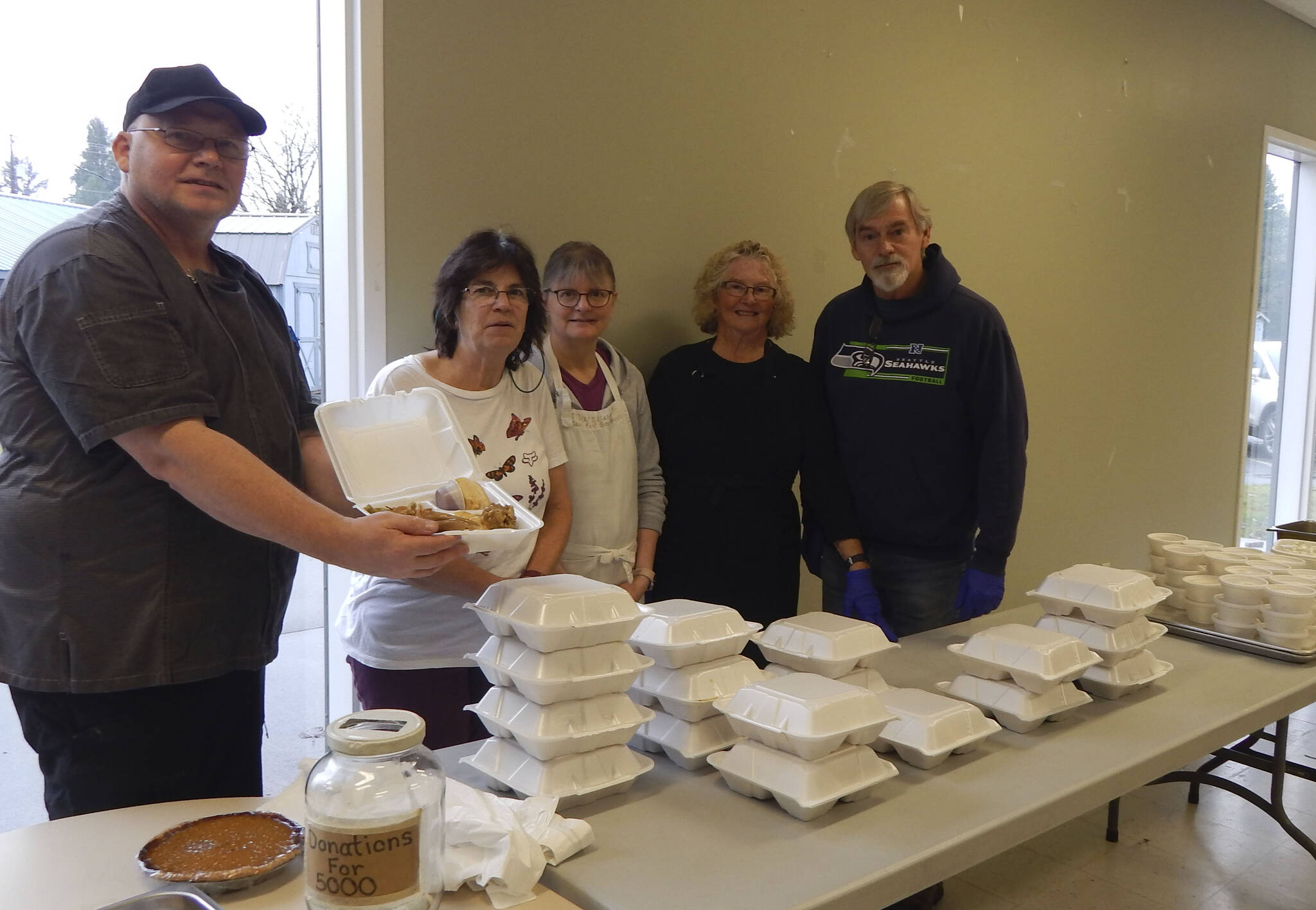 Feeding 5000 volunteers provided 135 Holiday meals to go last Tuesday; turkey, ham, stuffing, mashed potatoes and gravy, and dessert were on the menu. Volunteers seen here are Eugene Fraker, Debbie Anderson, Christie Stallman, Sherry Schaff, and Pastor Bob Schwartz. Other volunteers not pictured are Don Grafstrom, Ohm-Rin Fraker, Ashley Debriae, Todd McGrail, Diane Gaydeski, and Edith Henry. Photo Christi Baron