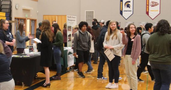 Students mingled about the tables where potential employers shared information about current and future employment opportunities.