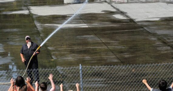 This was the only action at the arena on the 4th as kids asked to be sprayed with water while the arena floor was being watered down prior to what was to be the annual Demolition Derby. The derby was canceled, however, as emergency vehicles were called out to a large brush and structure fire along Bogachiel Way in Forks. Photo by Lonnie Archibald