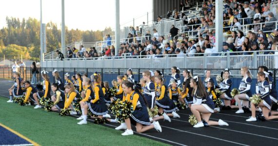 West End Youth cheerleaders joined the Forks High School cheerleaders during homecoming. Pictured here sportsmanship is shown as they kneel while an injured Timberwolves player is tended to. More on Spartan Homecoming on page 7. Photo by Lonnie Archibald