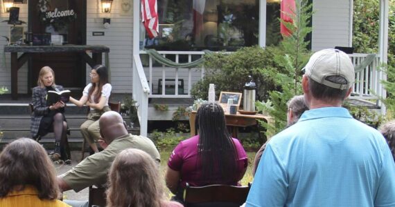 Author M.B. Thurman reads from her debut novel, Summoned, in front of the Miller Tree Inn, aka the Cullen House, during a pre-FTF event last Tuesday. M.B. (Mary Beth) and her husband Trent own the Inn. The FTF Festival also featured other authors at several other venues throughout the celebration. Photo Christi Baron