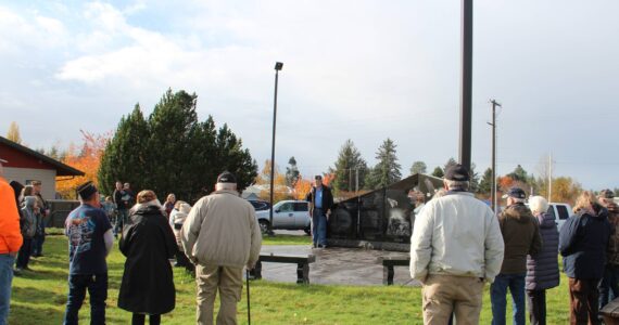 Joe Wright, Forks American Legion, center of photo, welcomed about 60 community members to the annual Veterans Day Ceremony at the Forks Transit Center last Saturday. Just before the ceremony the rain quit! and stayed away the entire ceremony. Meg Rasmussen offered TAPS. Pastor George Williams, Forks Bible Church, offered a short message and prayer. Photo Christi Baron