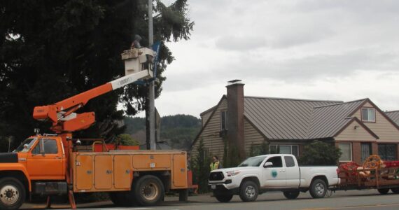 City of Forks Public Works crew members worked last week to get the downtown Christmas decorations up. Photo Christi Baron