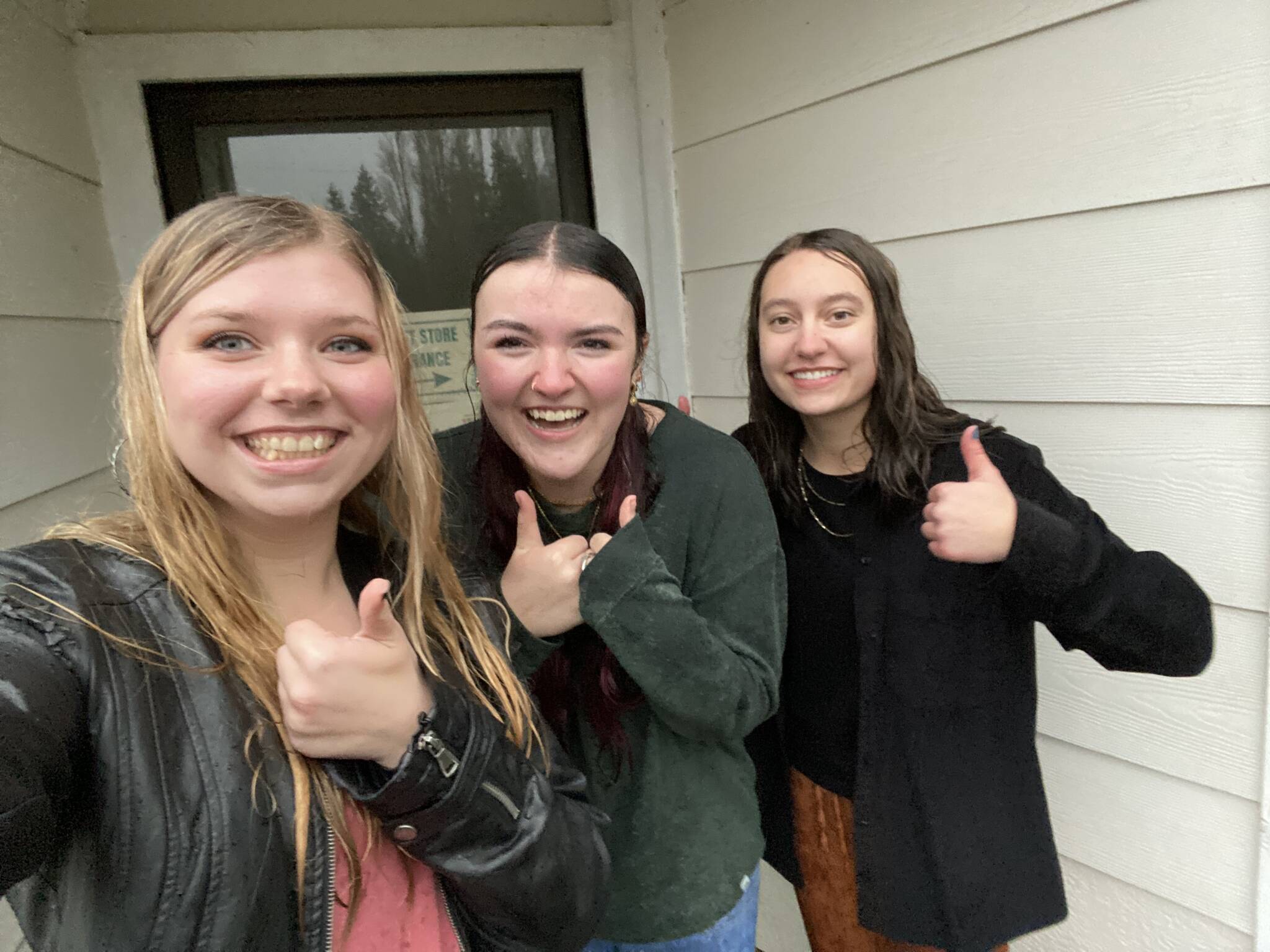 NHS Vice President, President, and Secretary delivering donations in a rainstorm! Photo Erame Tost