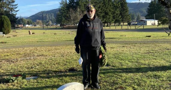 Veteran and American Legion member Joe Offutt looks on after placing a wreath at the grave of Dean Kilgore. Kilgore was born in Missouri in 1897 and served during WWI. He was a member of the American Legion and teacher and Superintendent at Quillayute Union High School and passed at the young age of 42 in 1940. Two hundred and two wreaths were placed at the Forks Cemetery on Saturday, December 16. Submitted Photo