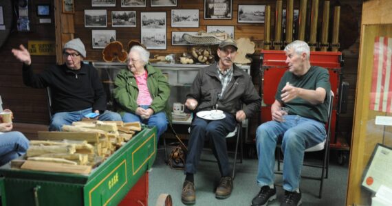 Richard Halverson shares a story at the Forks Timber Museum on Tuesday, Dec. 19. Shirley Sharpes listens while Bruce Paul and Tom Rosmond share a conversation. Halverson and Rosmond are on the Timber Museum Board. The Museum Board held its last meeting of the year at the Museum before hosting the West End Historical Society for lunch. Photos Lonnie Archibald