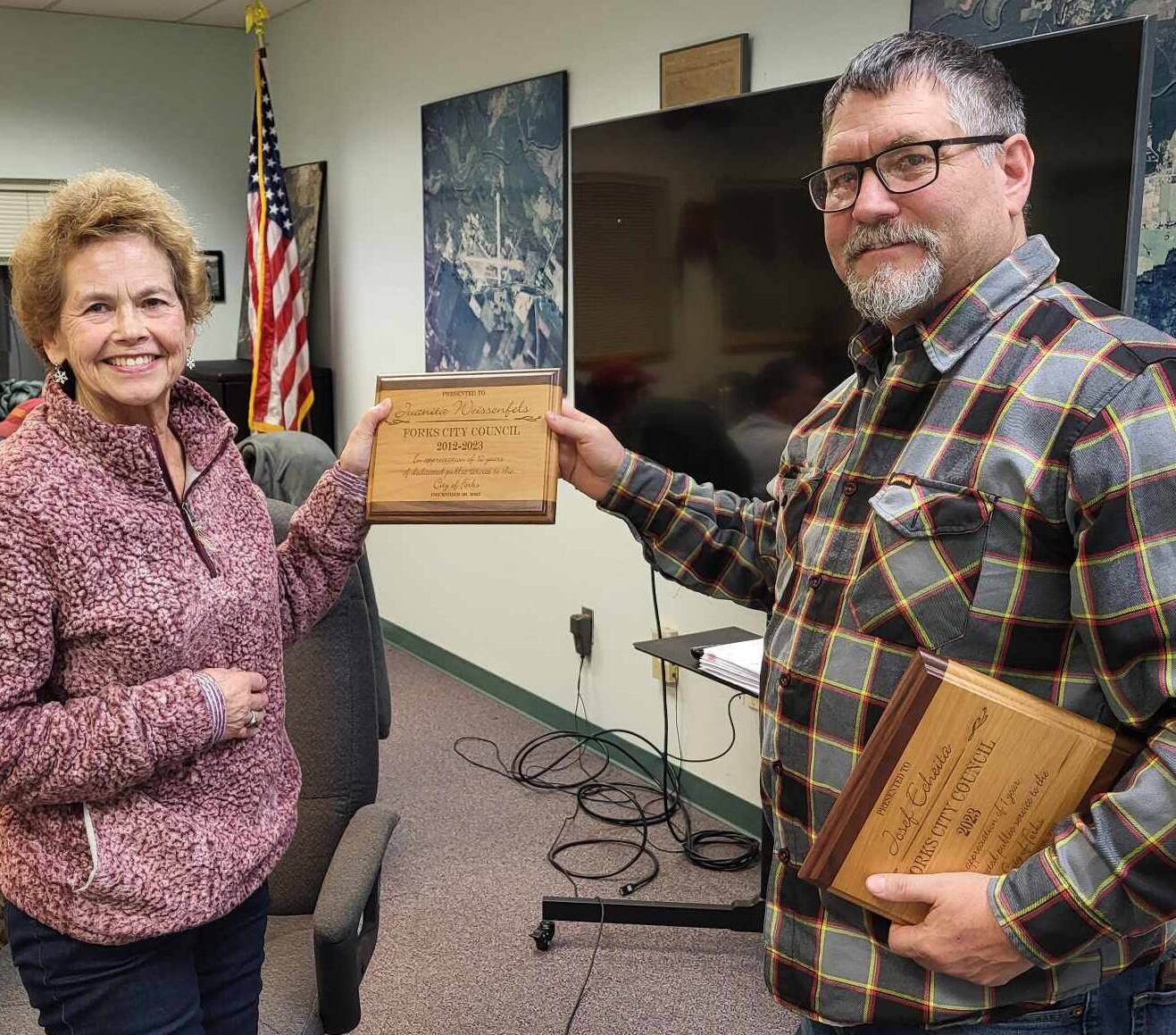 Juanita Weissenfels accepts a plaque from Forks Mayor Tim Fletcher at her last meeting as a Forks City council member.