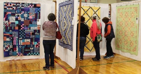 Over 100 beautiful quilts were on display over the weekend at the FHS auxiliary gym during the Piecemaker’s annual Fabric of the Forest Quilt Show. Here attendees take a closer look at some of the fine work done by local quilters. Winners of raffle items were - Quilts - Gretchen Fleck and Margaret Voyles; the gift basket winner was Pam Ogier. The club also offered several quilting classes. Photo Christi Baron