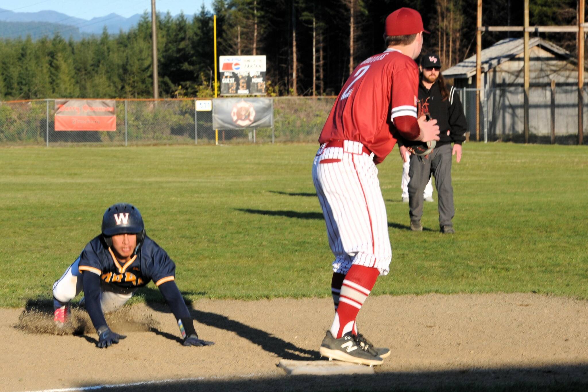 Spartan Aidan Salazar slides safely into third during this nonleague contest against Hoquiam played on April 18 at the Fred Orr Memorial Park. Forks won 13 to 3 with the ten-run rule in the 6th inning. Photo by
Lonnie
Archibald