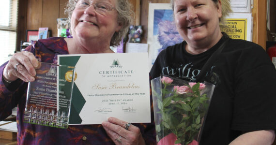 Citizen of the Year Susie Brandelius was unable to attend the Forks Chamber of Commerce Best of Awards event on April 17. She is seen here with the Forks Chamber of Commerce Executive Director, Lissy Andros, who caught up with her on Monday, April 22 at her office to present her award and flowers. Susie was recognized for helping seniors in the community as well as helping with resources for relatives raising relatives and more. Photo Christi Baron