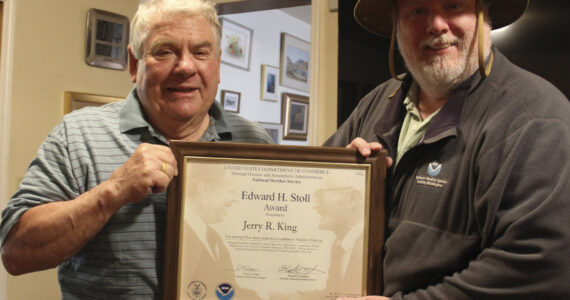 Jerry King on the left receives his latest award, the Stoll Award, recognizing his over fifty years of weather data keeping. John Burg from NOAA on the right presented the framed certificate. Photo Christi Baron