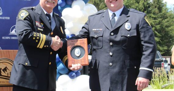 Speers presents Jacob Claussen with the 2023 Corrections Officer of the Year Award. Speers said Claussen leads by example. Photos Christi Baron