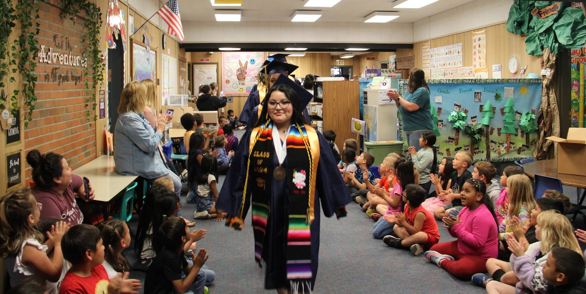 In what has become a tradition FHS grads walked the halls of all QVSD schools on Friday afternoon before graduation weekend. They started here at Forks Elementary and continued on to the other buildings …then boarded a school bus and rode through town and did a walk through Forks Outfitters. Photo Christi Baron