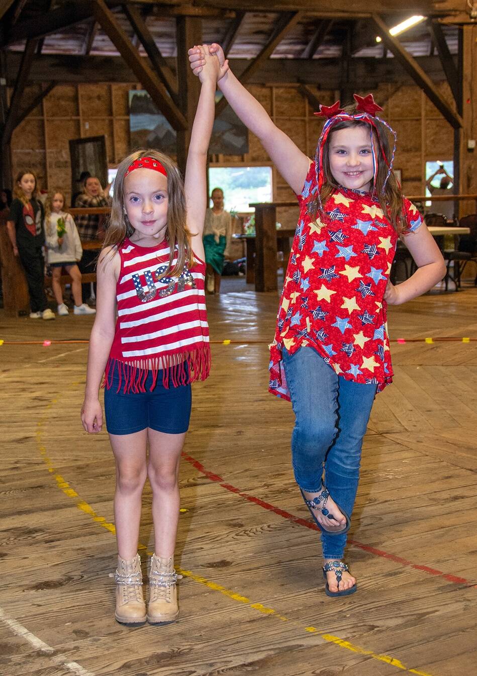 It was time to get your “style on” at the Ginger’s Closet Fundraiser held Saturday evening, June 29, at the Roundhouse. Models of all ages presented outfits from the non-profit. These two pictured, even found something to wear for the 4th!
In addition to the fashion show, attendees snacked on tacos, the Forks Lions provided a beer garden, and the Richwine Road Band provided entertainment. Ginger’s Executive Director Layla Rawls shared, “Thanks to our community’s incredible generosity, we raised nearly $4,000. Next fall 2025, we will award two $2,000 scholarships in honor of our founder, Ginger Haberman. Applications will be available next spring.” Ginger’s says thanks to all who volunteered!
Photo
Dave Youngberg