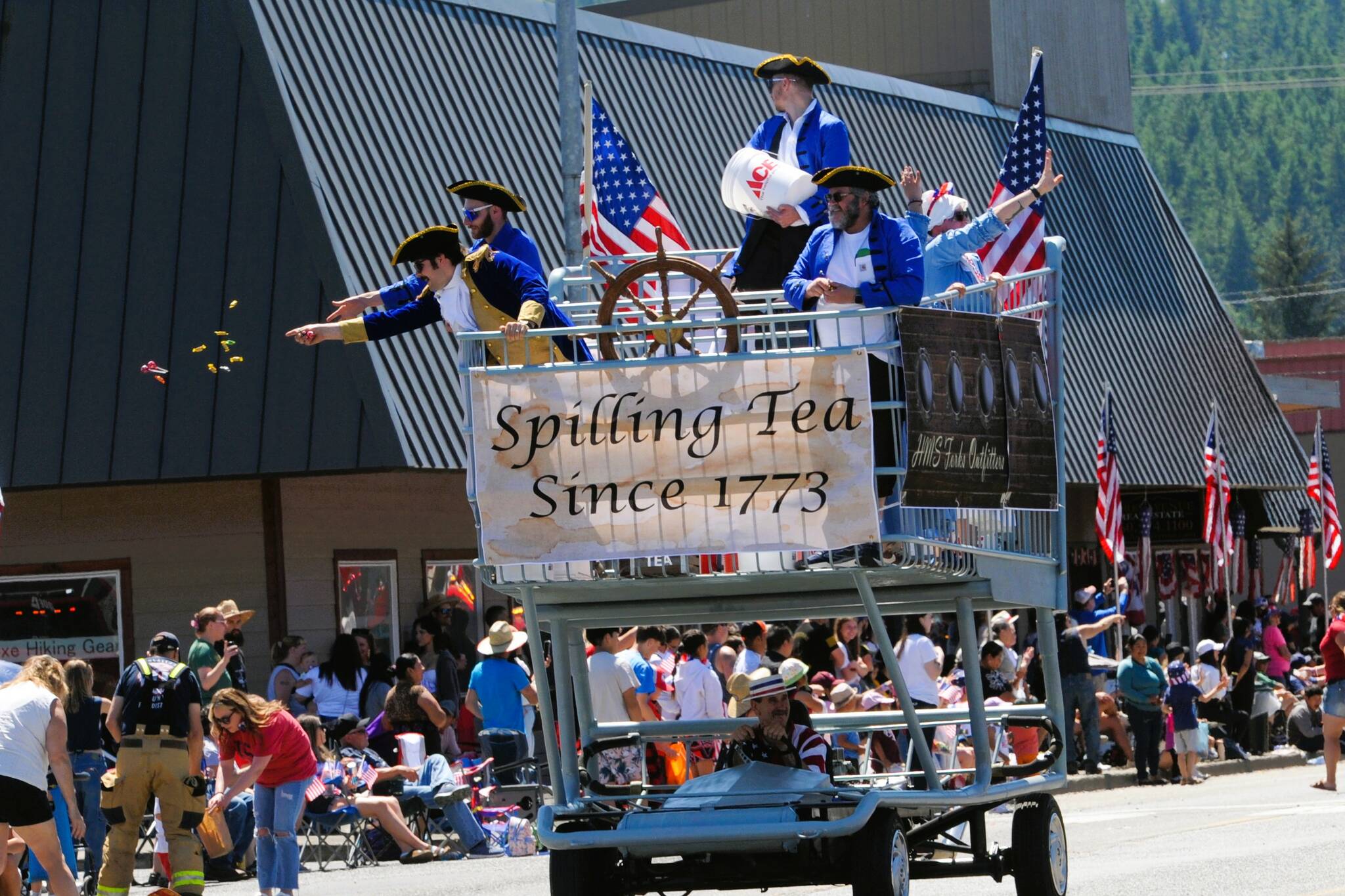 Always a parade favorite …the Forks Outfitters big shopping cart. Did they throw out any tea? or just a whole lot of candy. Photo Lonnie Archibald