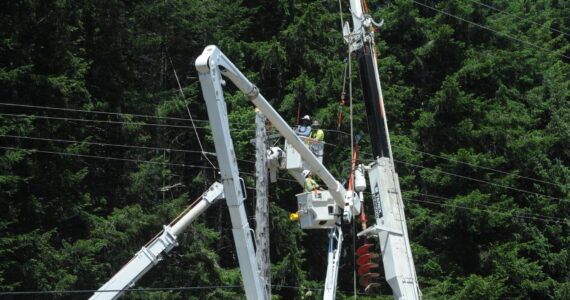 Outdated power poles along Highway 101, near milepost 198, are being replaced by Sturgeon Electric of Troutdale Oregon. Clallam County PUD Commissioner for District 3 Phyllis Bernard shared some details about the project with the West End Business group last Wednesday. Bernard also listened to concerns from the group regarding long BPA outages that affect the West End multiple times each winter. Photo Lonnie Archibald