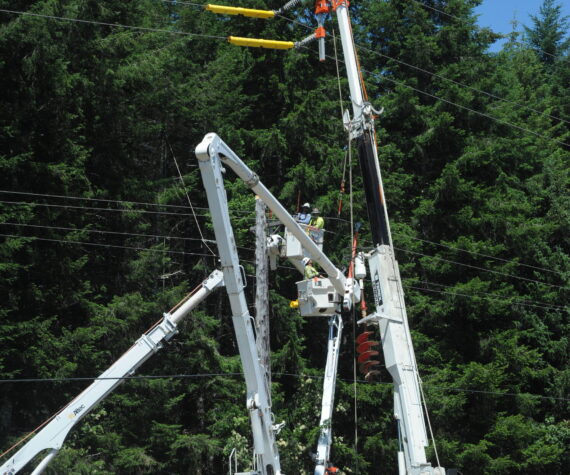 Outdated power poles along Highway 101, near milepost 198, are being replaced by Sturgeon Electric of Troutdale Oregon. Clallam County PUD Commissioner for District 3 Phyllis Bernard shared some details about the project with the West End Business group last Wednesday. Bernard also listened to concerns from the group regarding long BPA outages that affect the West End multiple times each winter. Photo Lonnie Archibald