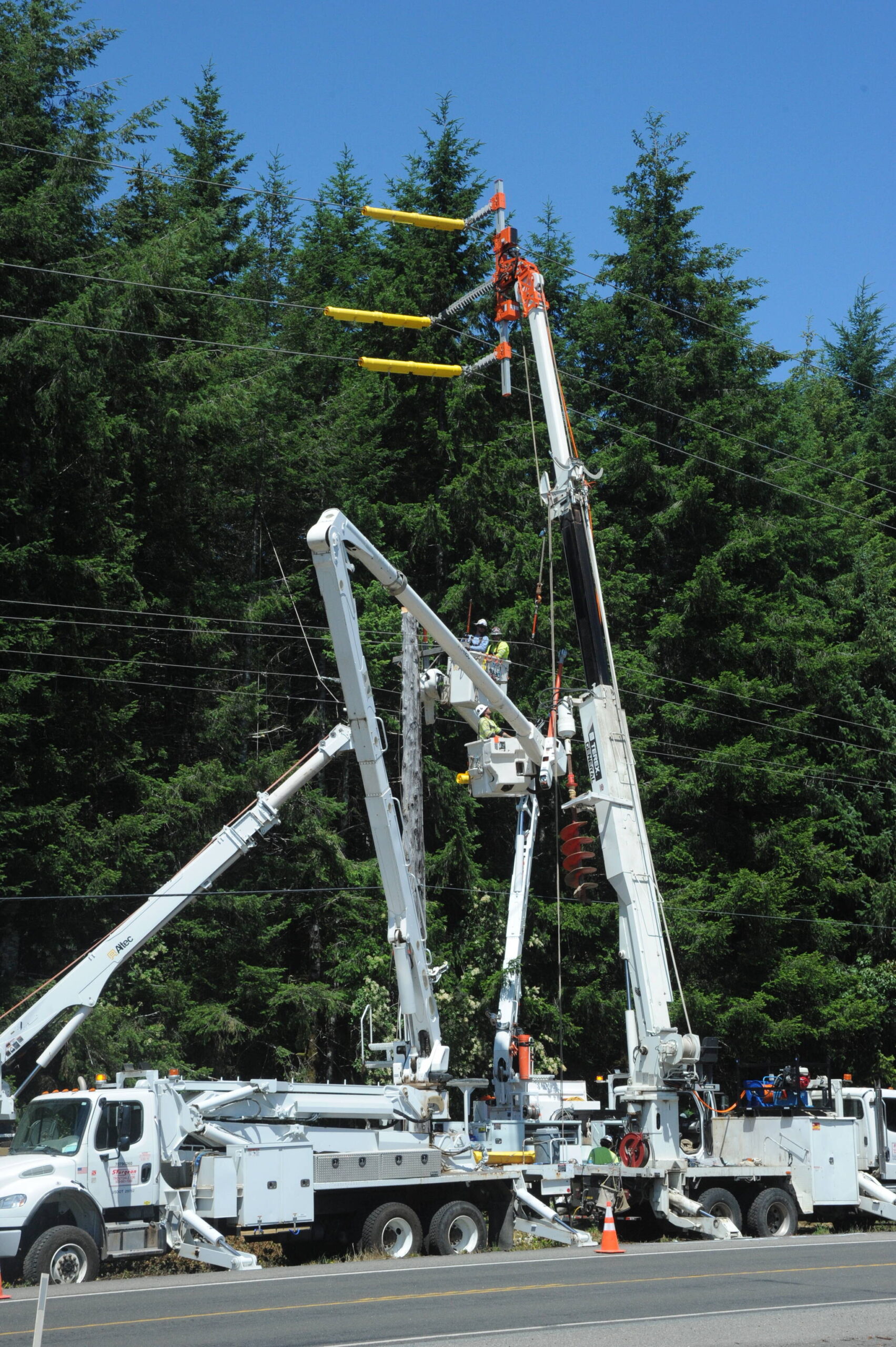 Outdated power poles along Highway 101, near milepost 198, are being replaced by Sturgeon Electric of Troutdale Oregon. Clallam County PUD Commissioner for District 3 Phyllis Bernard shared some details about the project with the West End Business group last Wednesday. Bernard also listened to concerns from the group regarding long BPA outages that affect the West End multiple times each winter. Photo Lonnie Archibald