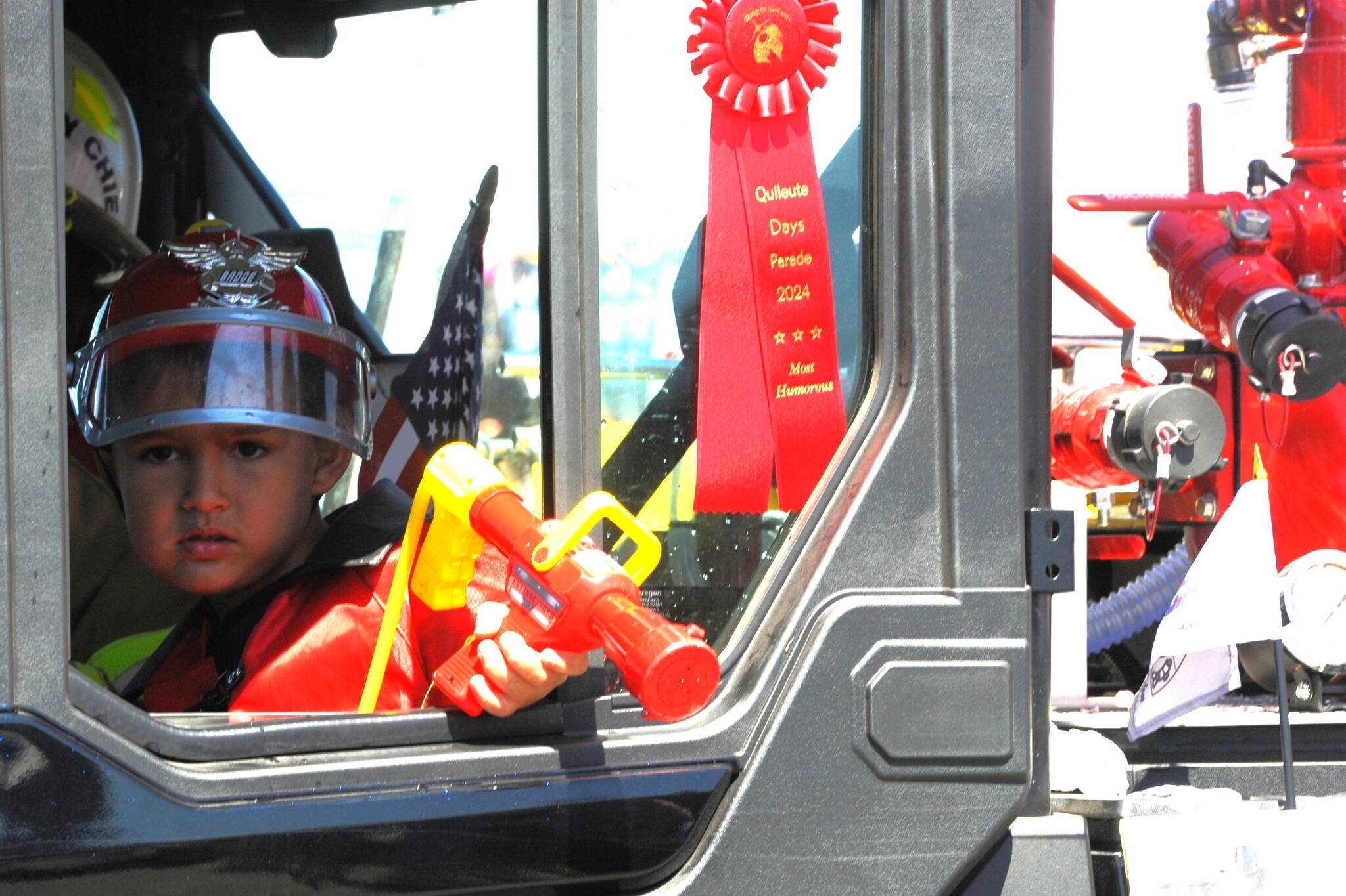 The little fire chief of the day was Kaylen Gorum as he rode in the new fire equipment belonging to the Quileute Tribal Fire Department. Photos by Lonnie Archibald