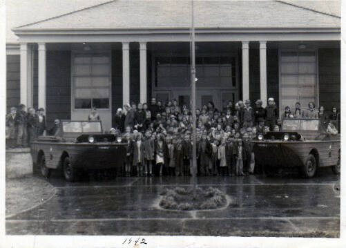 This photo was taken in 1942 outside the School’s Annex building. At the time the building may have served grade school children. The reason for and who is in the photo has been lost to time.
Adria Fuhrman brought the photo into the Forks Forum hoping that someone who was in the photo might remember the occasion or may have heard from someone who was in the photo what was going on here.
May be associated with the Quillayute Naval Air Station or some other branch of the military? Thanks for any information on this photo!