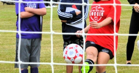 Tessa Holt age thirteen, finds the net while her competition looks on.