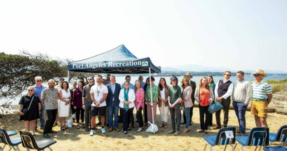 U.S. Rep. Derek Kilmer, D-Gig Harbor, and members of the North Olympic Peninsula Recompete Coalition stand together following a press conference at Harborview Park on Friday in Port Angeles. (Christopher Urquia/Peninsula Daily News)