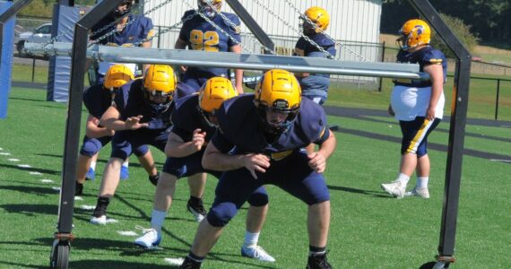 Forks High School linemen go through drills in preparation for the upcoming football season. Photo by Lonnie Archibald