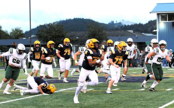 Spartan Emmanuel Hernandez-Stansbury on his long TD run against the Roughriders in the first quarter of play Friday night at Spartan Stadium. Also in the action are Spartans Landen Olson (10), Kaden Ward (23), Cash Barajas (11), Kenny Daman (75), and Jeremy Hutto (72). Forks defeated Port Angeles 13 to 7. Photo by Lonnie Archibald