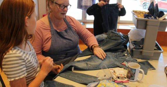 Patsy Brown demonstrates some patching of denim …at the RAC on Saturday.