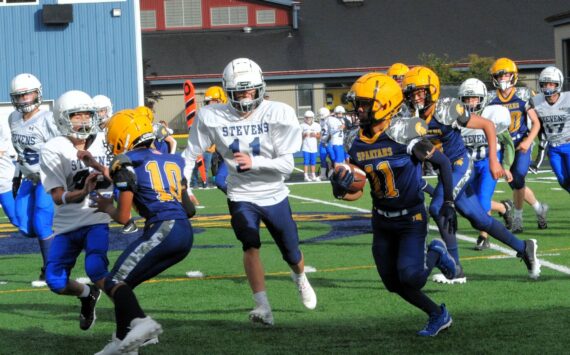 In Forks Middle School football, Stevens of Port Angeles just got by Forks with a 31 to 28 score in this thriller. Pictured here Spartan Pedro Francisco Marcos (11) picked up good yardage behind the blocking of Thomas Penn (10). The next home game is scheduled for Oct. 9 at 4 p.m., against Sequim. Photo by Lonnie Archibald