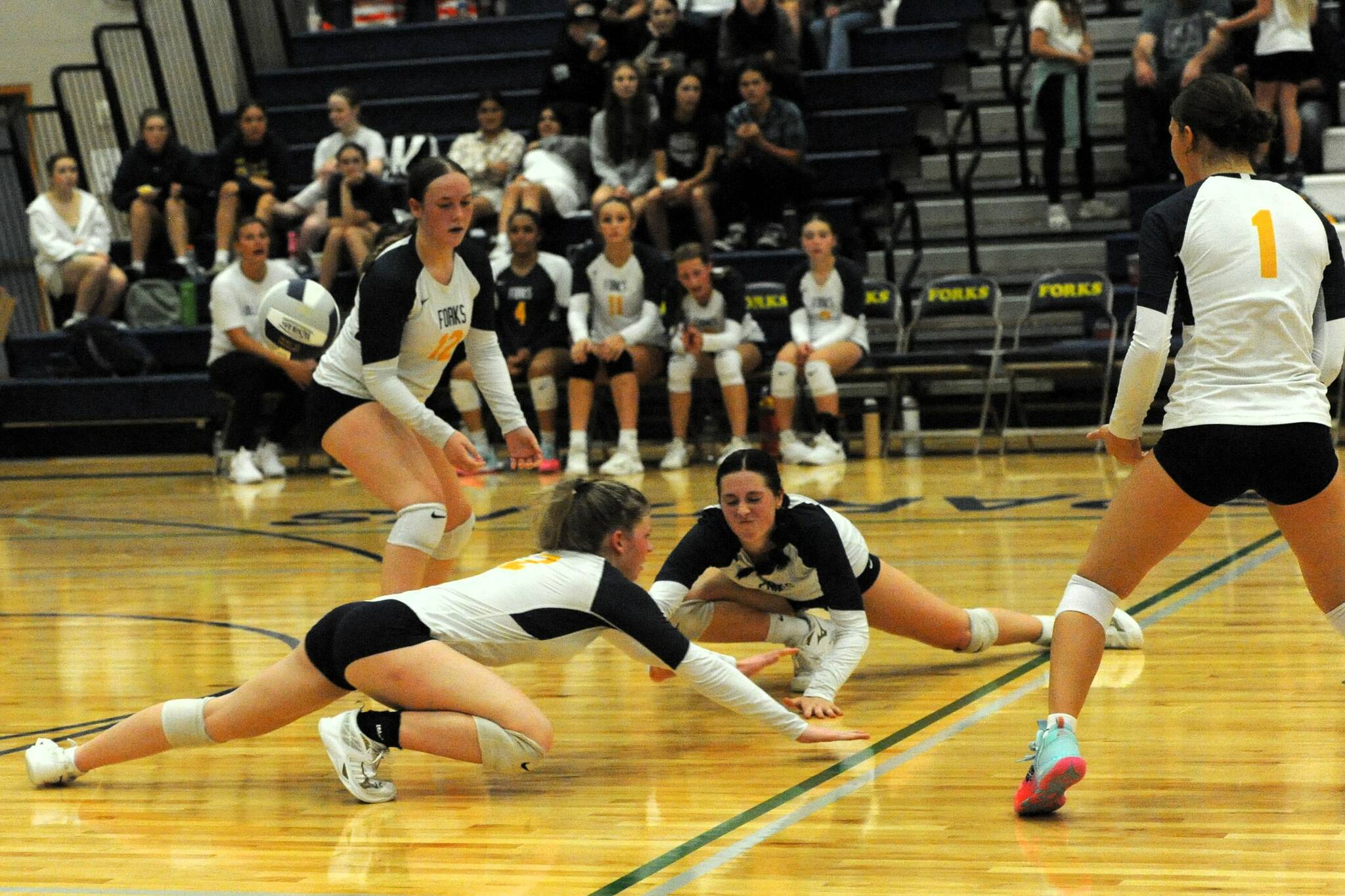 Typical of the Spartan’s fight for victory, Bailey Johnson and Chloe Gaydeski dive in an attempt to dig while teammates Fyn Peters and Erica Williams look on. There was great hustle by both teams in this contest won by Forks 3 to 2 over the Hoquiam Grizzlies on Sept. 24 in the Spartan Gym. Photo by Lonnie Archibald