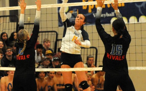 Spartan Avery Dilley (11 ) hits against East Jefferson’s Emily Lisk (8) and Penina Vailolo (15) on Sept. 26 in the Spartan Gym where Forks, after losing the first set, came back to defeat the Rivals 3 to 1 in this nonleague contest. Photo by Lonnie Archibald